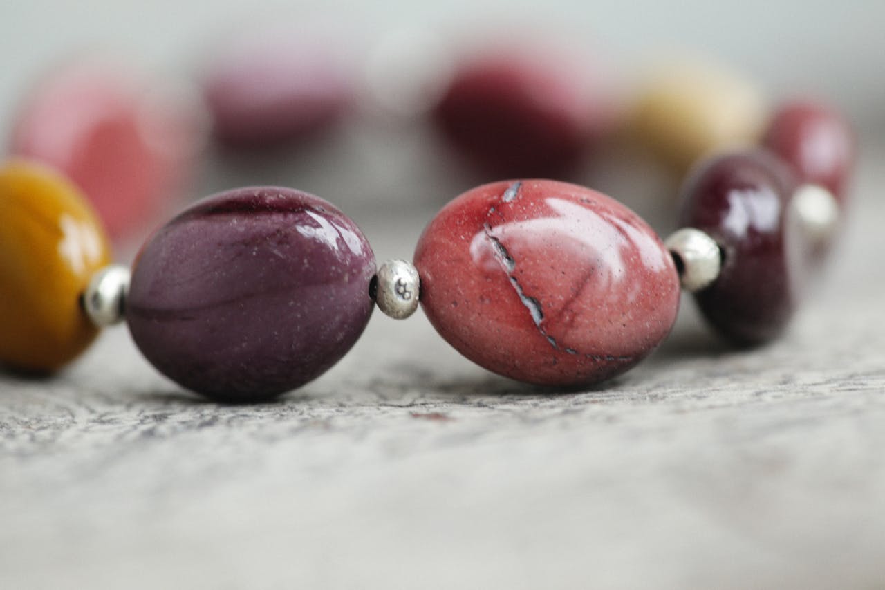 Detailed view of a multi-colored gemstone bracelet highlighting various hues.